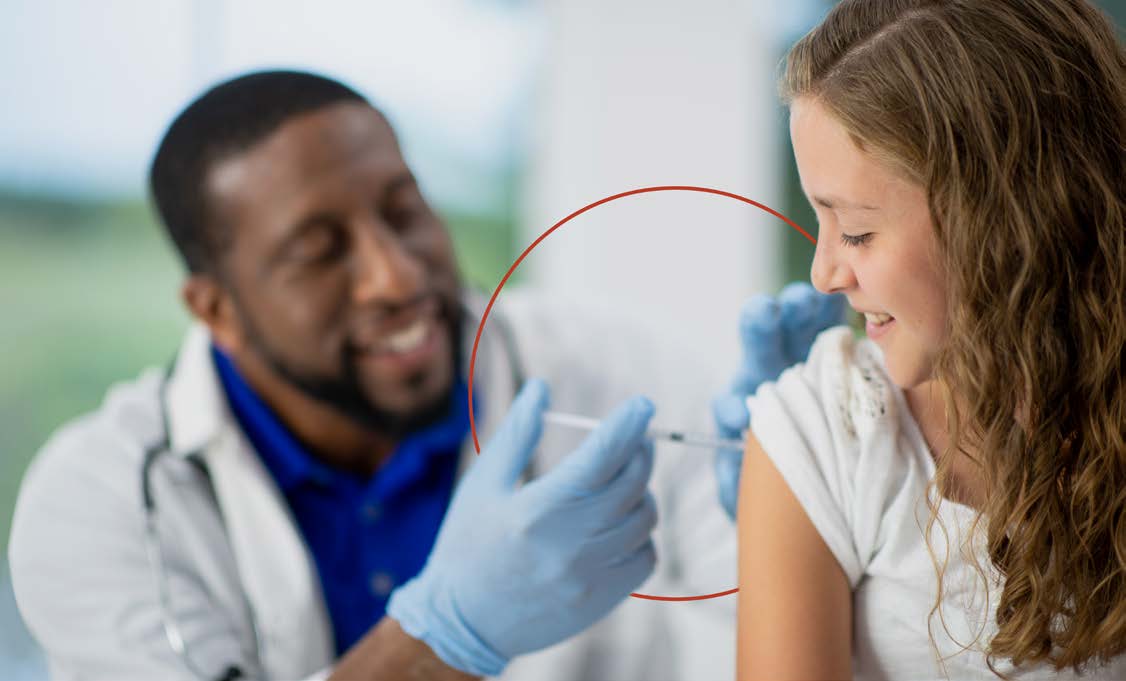 A HCP giving a young girl an injection